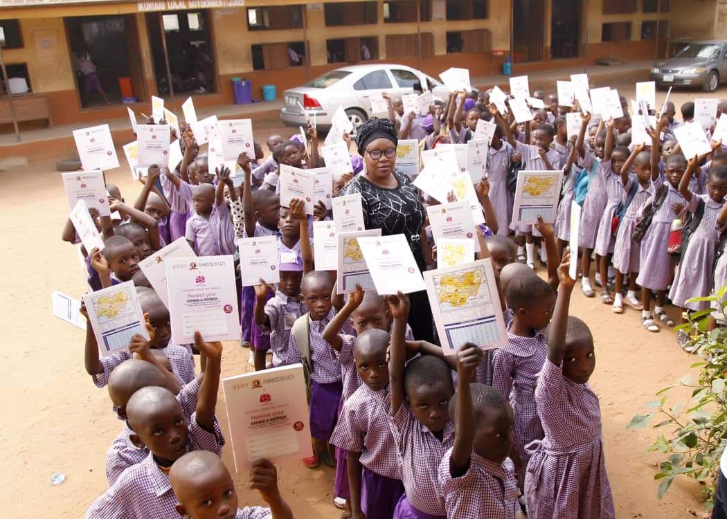 Children holding learning materials