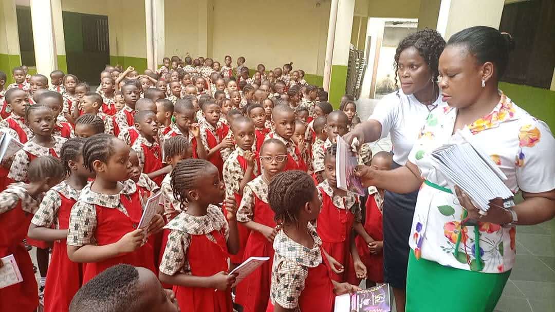 Children receiving educational materials